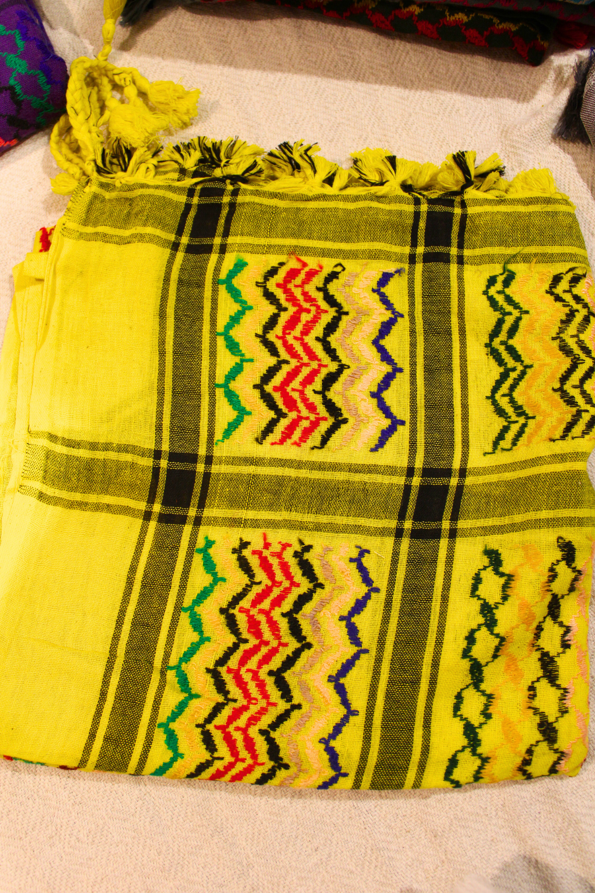 Lively lemon yellow Keffiyeh scarf, handcrafted with intricate cultural patterns and premium materials.