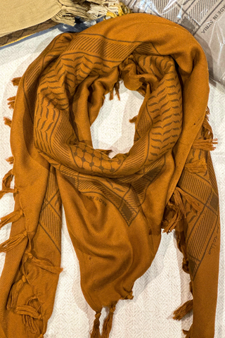 Detailed view of the vibrant printed patterns on the Ginger Kuffiyeh scarf, highlighting the beautiful fusion of contemporary design and traditional craftsmanship.