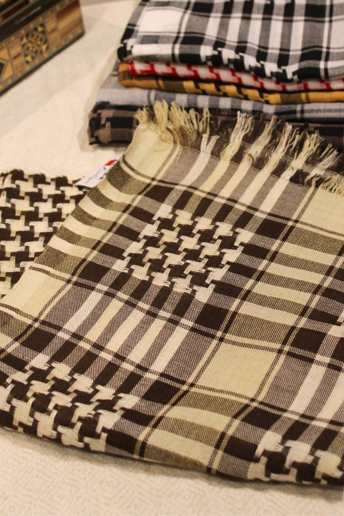 Beige Kuffiyeh scarf elegantly displayed to emphasize its classic color and rich cultural heritage.