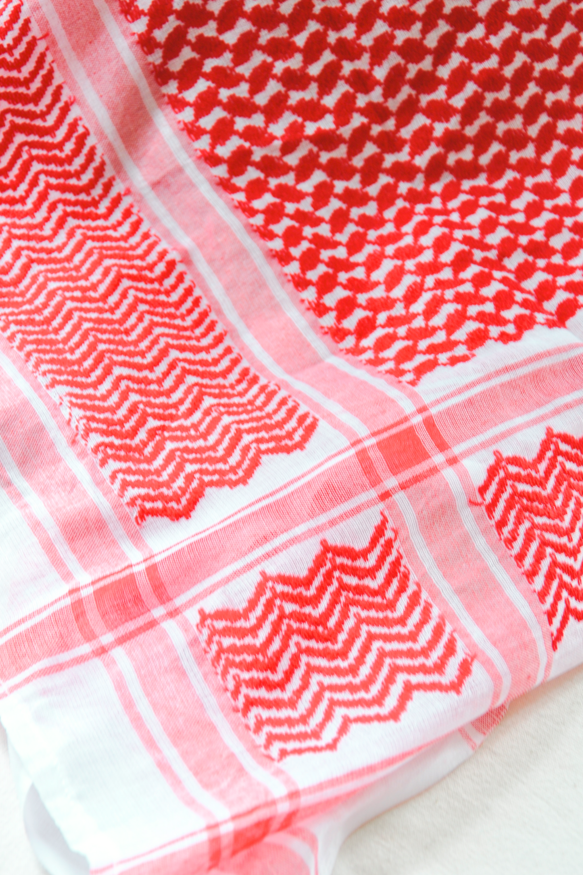 Heritage red and white Keffiyeh scarf without tassels, designed to offer a simple yet meaningful expression of Middle Eastern tradition. Handmade to add a timeless touch to any wardrobe.