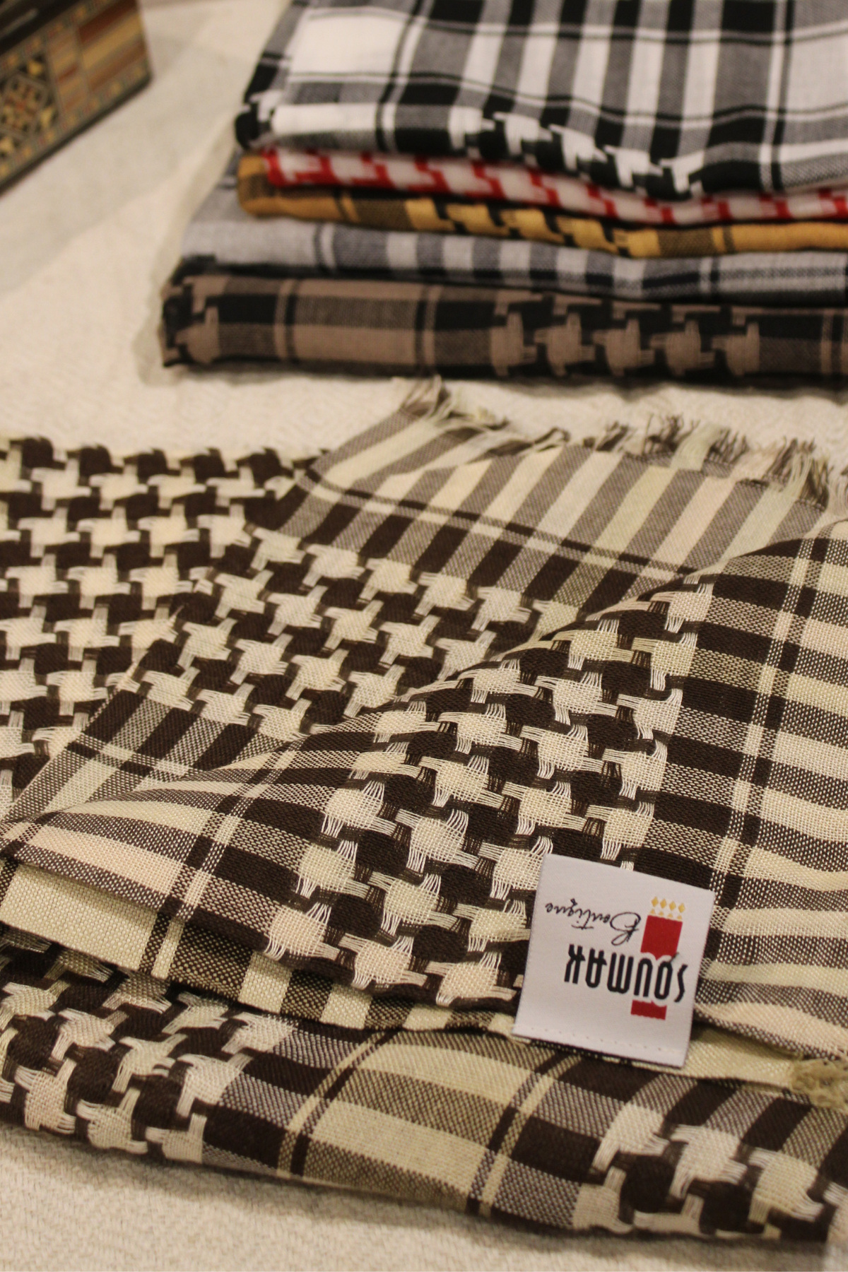 Beige Kuffiyeh scarf styled in various ways, perfect for both casual and formal occasions, enhancing any outfit.