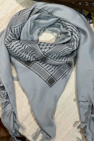 Stylish light blue Kuffiyeh scarf featuring exquisite printed patterns, perfect for enhancing any outfit.