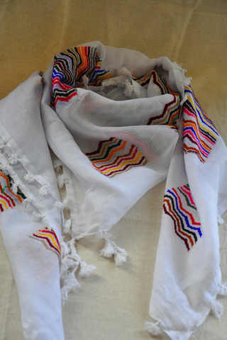 A stunning handcrafted White Syrian Kuffieyeh scarf featuring vibrant patterns, expertly blending modern design with traditional craftsmanship.
